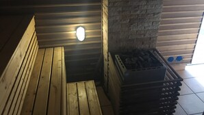 A wooden bench, a stone pillar, and a stack of crates in a dimly lit room with a sloped ceiling. - Pratumnak 1 bed With sea View at Siam Oriental Twins (Pattaya)