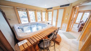 A hot tub with wooden seating and a view of the outdoors. - Chateaux Dumont 2709 (Keystone)