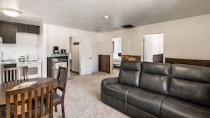 A compact living space with a kitchenette, a dining area, and a seating area. - Cozy Condo, 1 Min to Yellowstone! Alpine #2 (West Yellowstone)