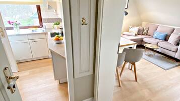 A modern interior with a kitchen, dining area, and living room.
