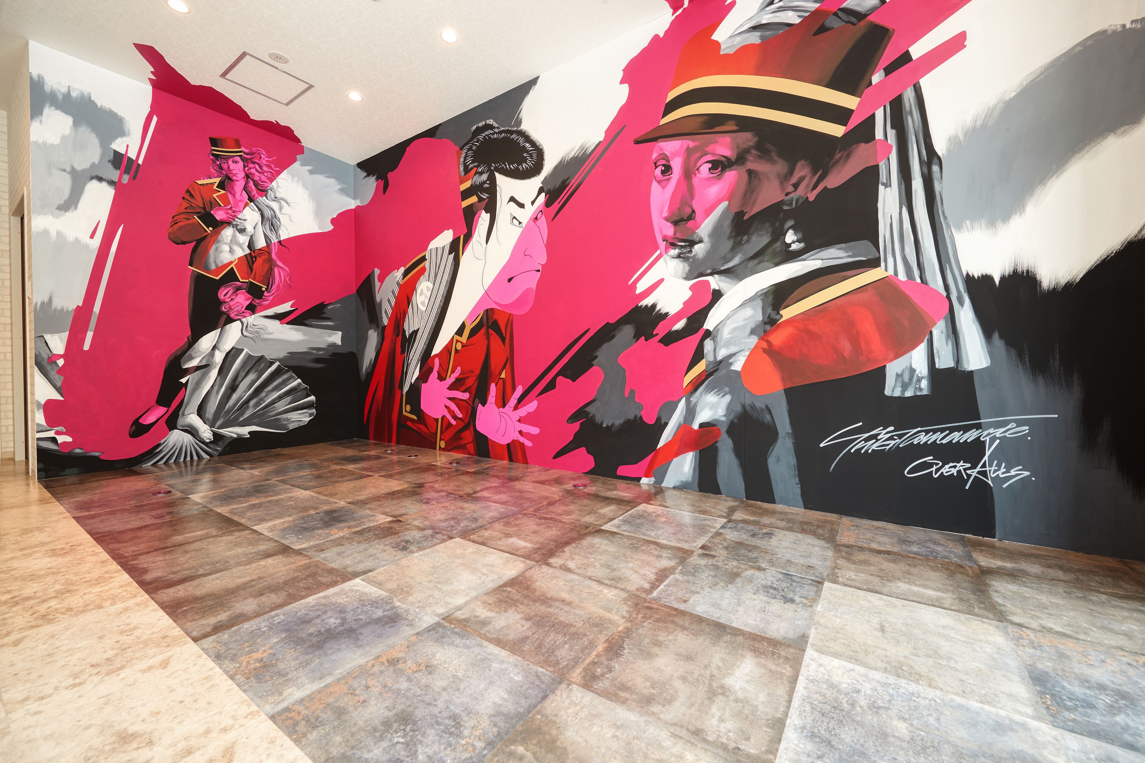 A hotel lobby with a large mural featuring abstract art and a tiled floor.