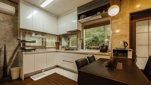 Enjoy cooking in this well-equipped kitchen with a stove, microwave, and coffee maker.