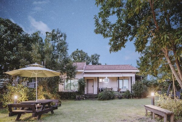 Stroll through the beautifully manicured lawn and enjoy a picnic at this charming two-story home.