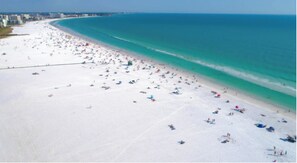 Enjoy a serene beach experience with access to the ocean and comfortable sun loungers.