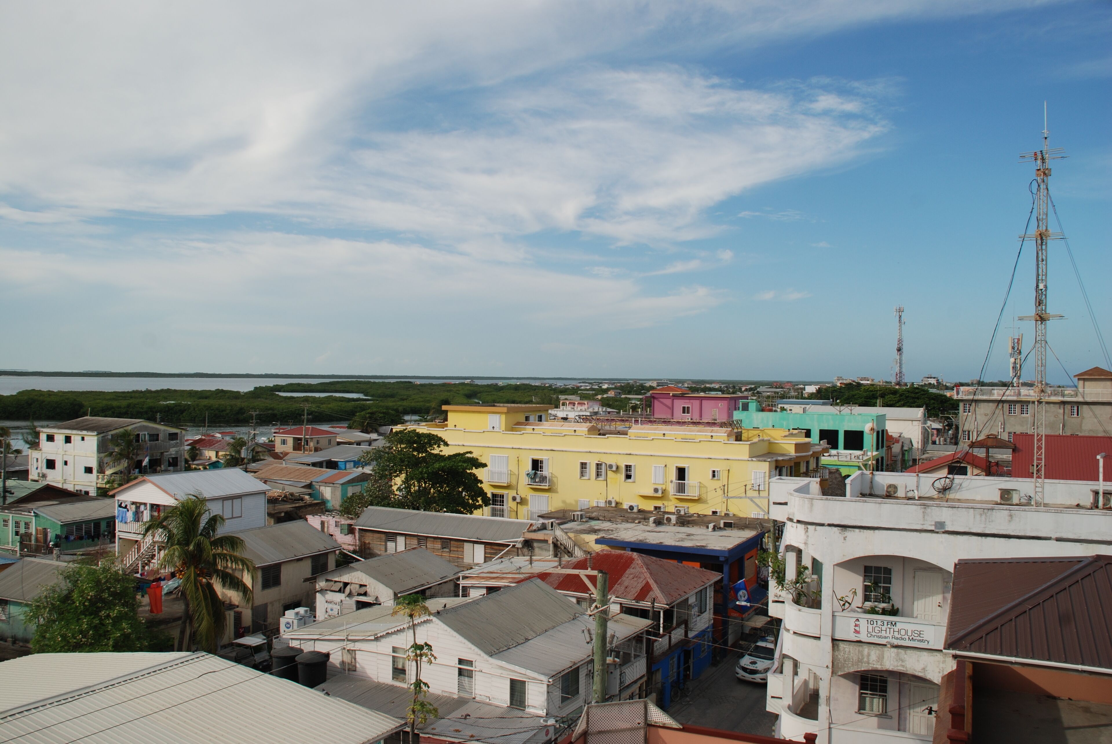 A coastal town with colorful buildings, including a lighthouse.