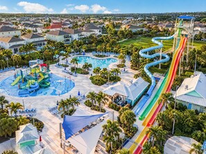 A water park with multiple slides and a pool area. - Magical Memories Villa: Pop Culture, Pool, Near Disney (Kissimmee)