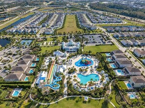 A residential area with a large swimming pool, water slides, and a clubhouse.