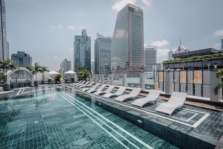 Outdoor pool, open 6:00 AM to 10:00 PM, pool umbrellas, sun loungers. Aira Hotel Bangkok