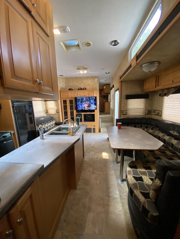 Enjoy meals in the compact kitchen with a sink and flat-screen TV.