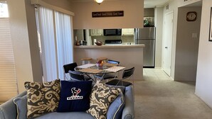 A compact living space with a dining area, kitchenette, and a cozy seating area with patterned cushions. - Houston Med Center/NRG Area 2B/2B All Inclusive (Houston)