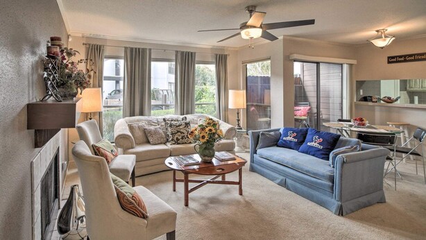 A spacious living room with a sofa, armchairs, a coffee table, and a dining area. - Houston Med Center/NRG Area 2B/2B All Inclusive (Houston)
