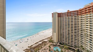 A high-rise hotel with a beach view, a swimming pool, and a sandy beach area. - Summer Deals!! Gulf Front, Beach Access + Parking! 17th Floor! Winter $1800/mo! (Panama City Beach)