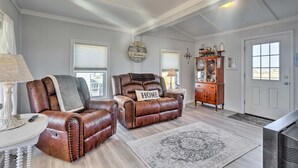 A living room with two leather armchairs, a wooden cabinet, and a large rug. - Seaside SK Getaway: Steps to Matunuck Beach! (South Kingstown)