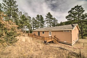 A single-story building with a wooden deck and a small porch.