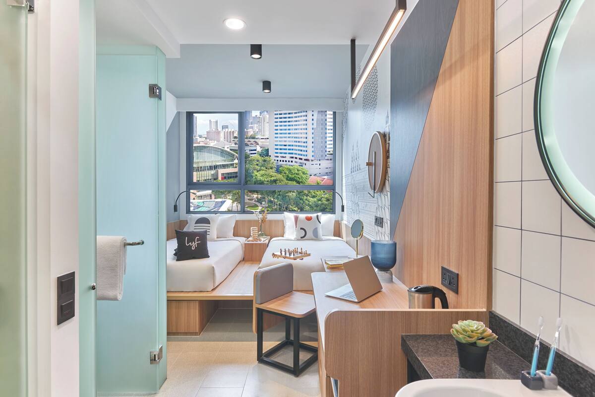 A modern bathroom with a sink, mirror, and toilet.