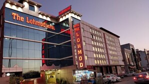 The Lohmod Hotel with a modern facade, large windows, and a prominent sign. - Lohmod Hotel (New Delhi)