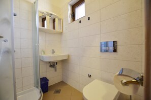 Shower, hair dryer, towels, toilet paper