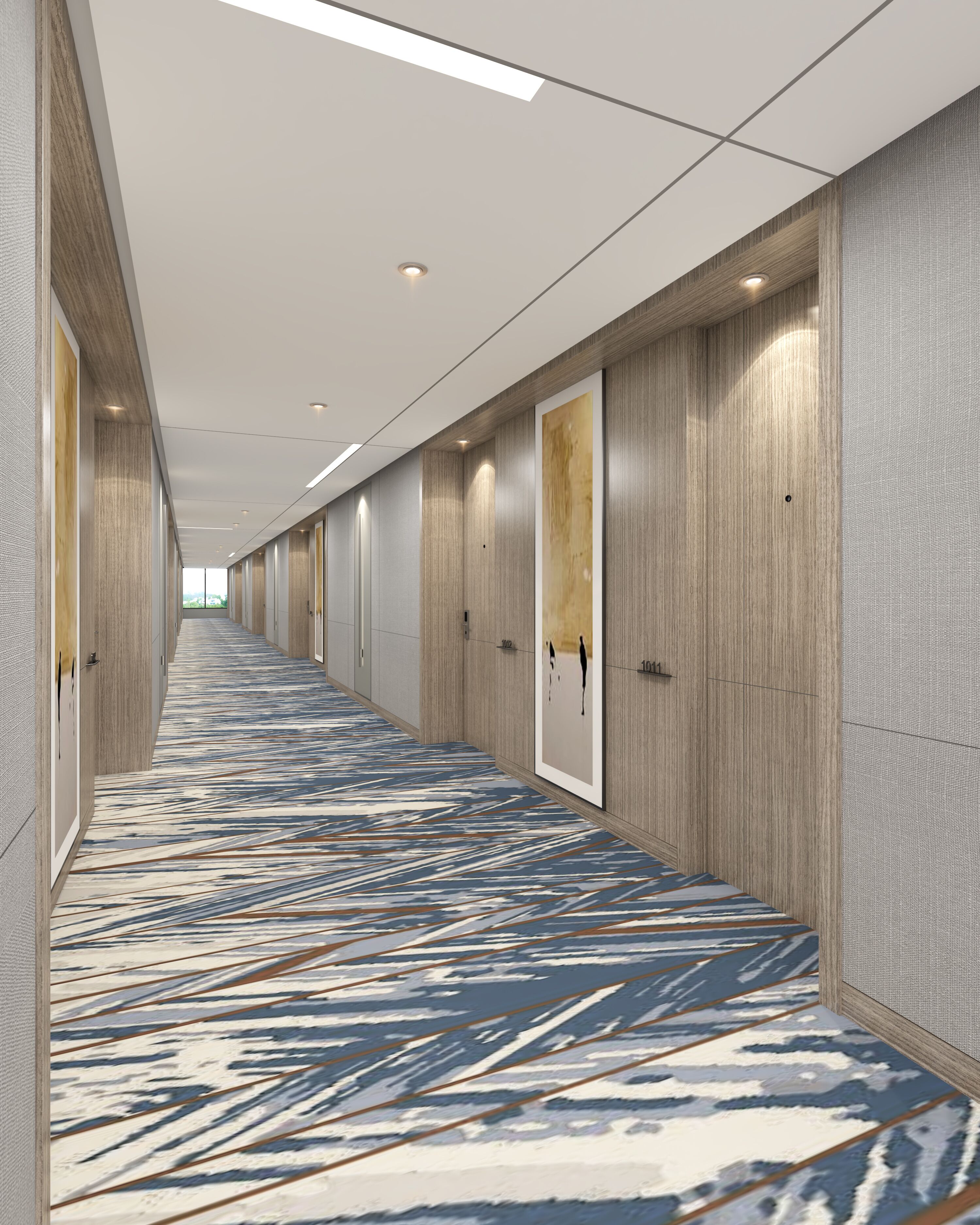 A long corridor with patterned carpet, wooden panel walls, and doors with handles.