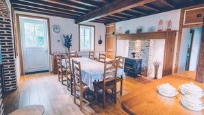 A cozy dining area with wooden furniture and a stone fireplace. - Fermette Les Ormes - Cottage 8 people in Merlimont village (Merlimont)