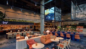 A modern bar area with seating and a large screen displaying an image. - Scandic Goteborg Central (Gothenburg)