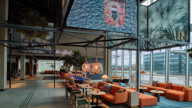A spacious lobby with modern seating, a reception area, and large windows offering views of the outside. - Scandic Goteborg Central (Gothenburg)