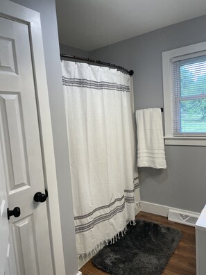 Combined shower/tub, hair dryer, towels, soap
