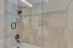 Bathtub, hair dryer, towels, shampoo