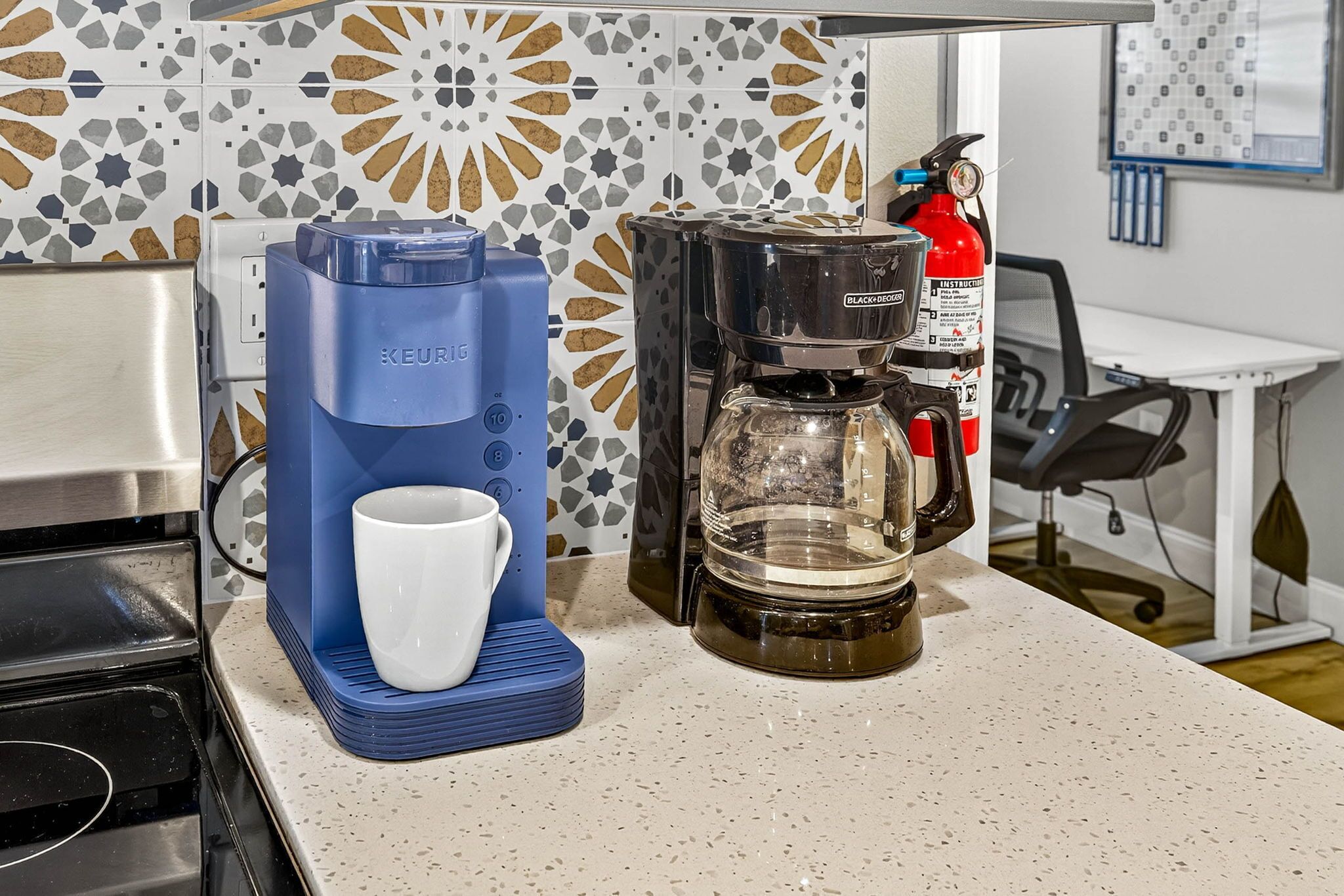 A coffee machine with a cup holder and a coffee pot on a kitchen counter.