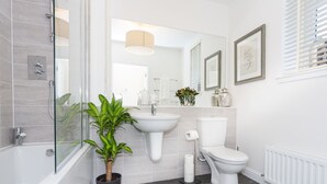A modern bathroom with a glass-enclosed shower, a white sink, a toilet, and a potted plant. - Enchanting Home Near Aberdeen, Scotland (Aberdeen)