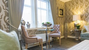 A cozy room with a window, a table with a bowl, two chairs, a lamp, and a sofa. - Enchanting Home Near Aberdeen, Scotland (Aberdeen)