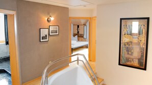 Een modern interieur met een wenteltrap, houten vloeren en een plafond met dakraam.