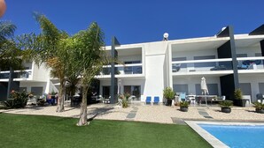 A modern hotel with a pool, outdoor seating, and a well-maintained garden. - A little corner of paradise in Vale de Parra (Guia)