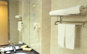A modern bathroom with a glass partition, a sink, a mirror, and a towel rack. - Greentree Inn Qinhuangdao Changli County Railway S (Qinhuangdao)