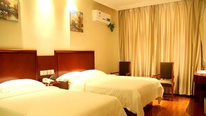 A hotel room with two beds, a desk, a chair, and a curtain. - Greentree Inn Qinhuangdao Changli County Railway S (Qinhuangdao)