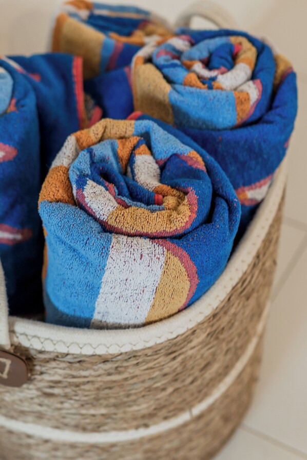 A woven basket filled with rolled blankets.
