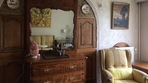 A room with a wooden dresser, a mirror, a chair, and a painting on the wall. - SHARED ROOM (Rennes)