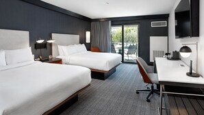 A hotel room with two beds, a desk, a chair, a TV, and a balcony with outdoor seating. - Courtyard by Marriott Richmond Scott’s Addition (Richmond)