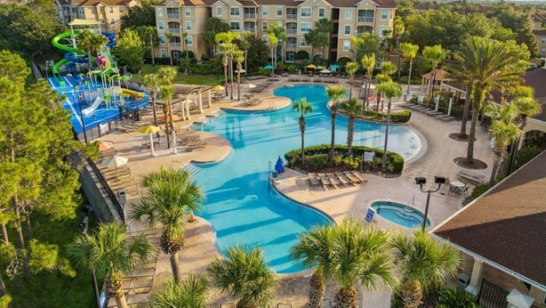 A hotel with a large pool area, including a water slide and multiple swimming pools.