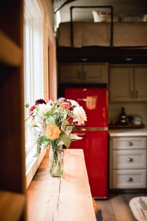 Enjoy cooking in this well-equipped kitchen with a refrigerator, sink, and ample countertop space.