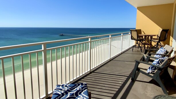 A balcony with a view of the ocean, a table with chairs, and a patterned sofa. - Beautiful 2/2 Condo at Sterling Reef~Great location~Sleeps 6~Beach svc. included (Panama City Beach)