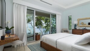 A modern bedroom with a large bed, a desk, a chair, and a view of the outdoors.