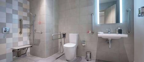 A modern bathroom with a toilet, sink, and shower.