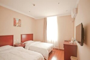 A hotel room with two beds, a desk, a chair, a TV, and a window with curtains. - Greentree Inn Liaoning Dalian Railway Station South Shengli Square Express Hotel (Dalian)