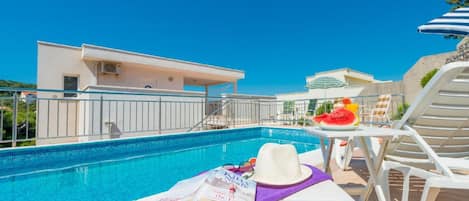 Studio (Deluxe Studio Apartment) | Pool | Seasonal outdoor pool, pool umbrellas, sun loungers