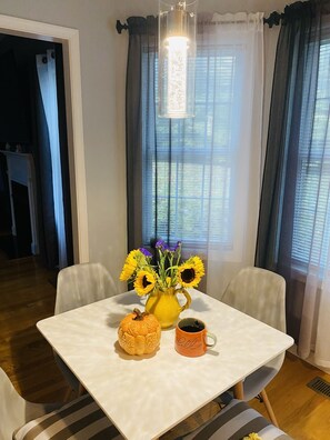 Enjoy meals for two at this cozy dining area, featuring a table set with a pitcher and mug.