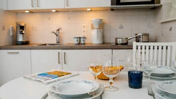 Fridge, stovetop, dishwasher, coffee/tea maker