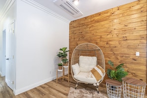 Relax in a cozy seating area with a comfortable chair and small table.