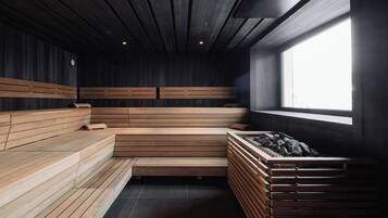 A sauna with wooden benches and a large window.