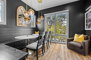 A modern dining area with a bench, table, and chairs.
