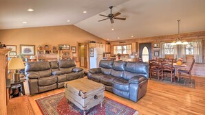 A spacious living room with leather sofas, a wooden coffee table, and a ceiling fan. - Bring a Pet! Mtn-View Bostic Retreat w/ Deck (Bostic)